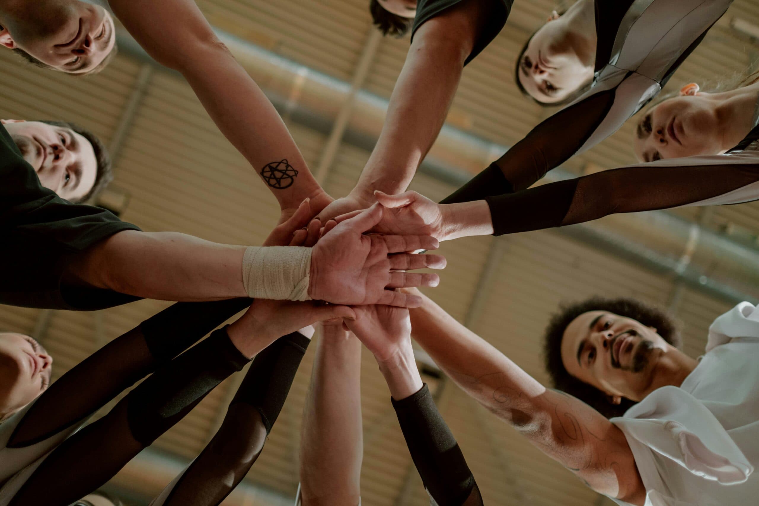 Photo by cottonbro studio: https://www.pexels.com/photo/group-of-people-joining-hands-together-7322769/